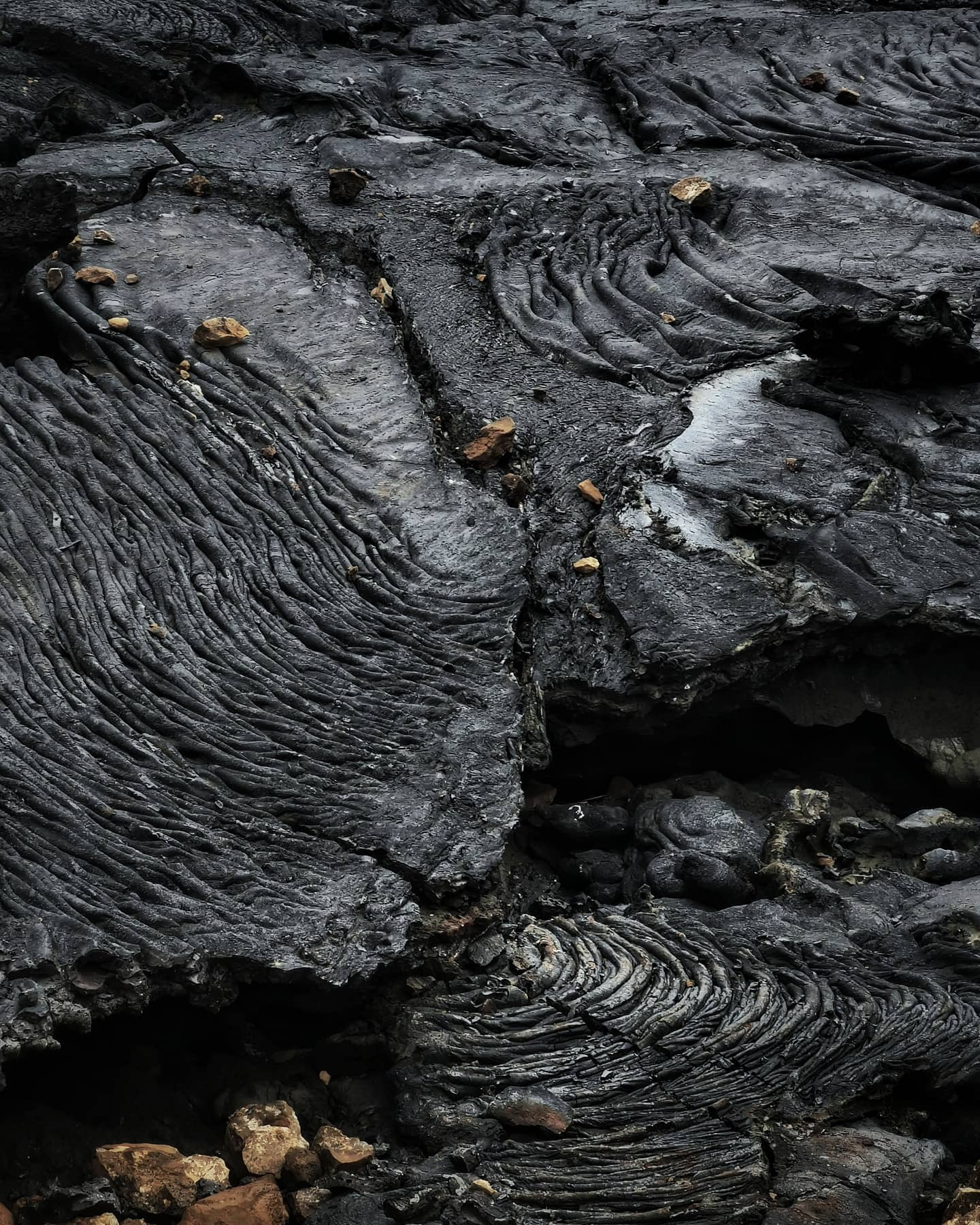 Hardened lava flow in tight black swirls