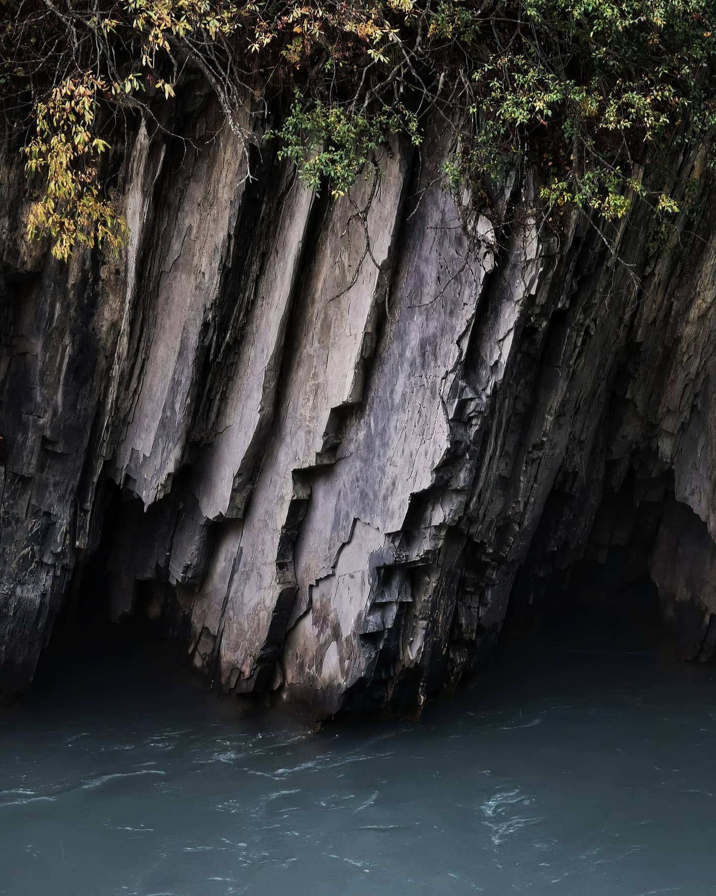 Basalt columns above pale turquoise river water